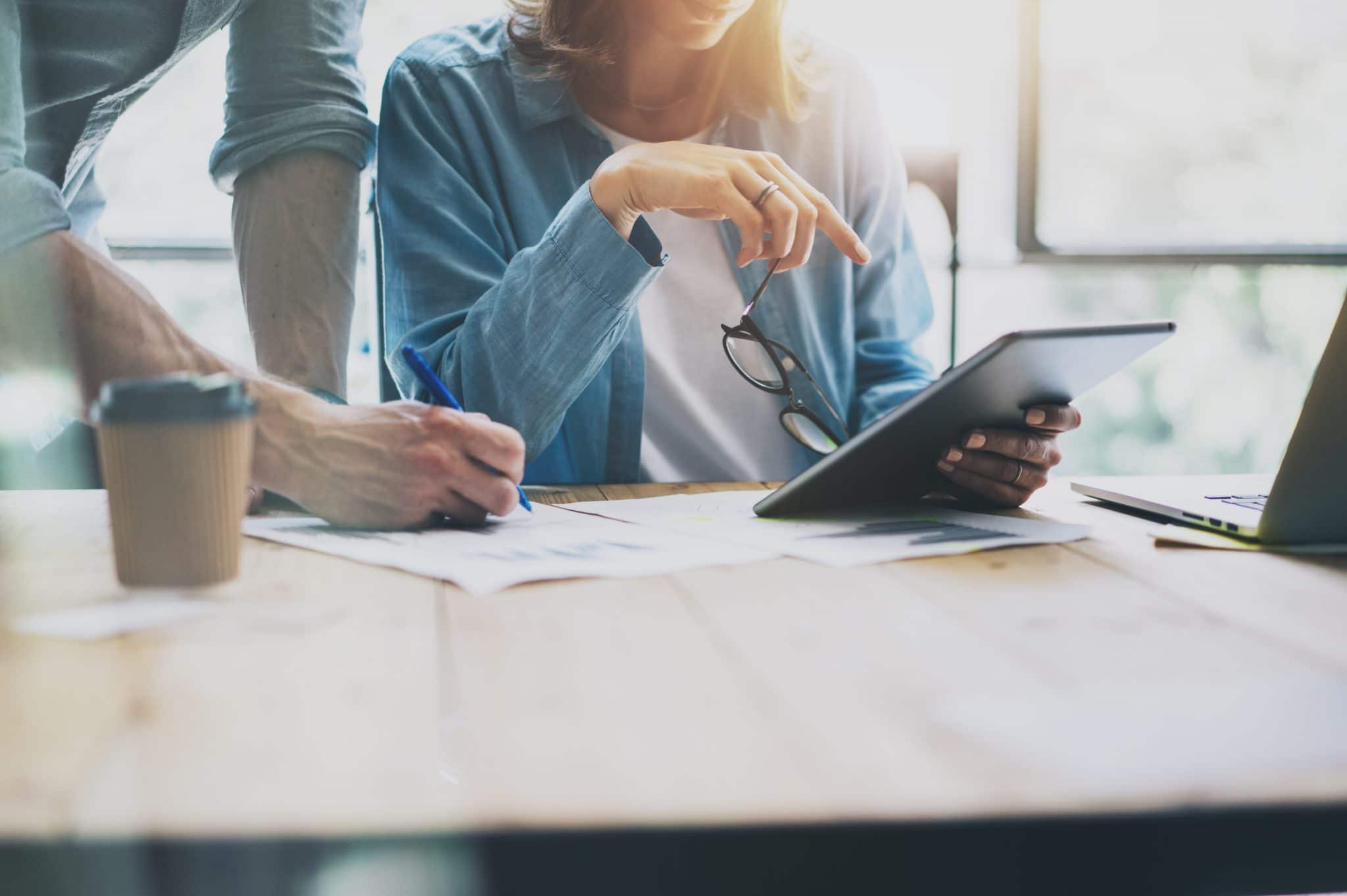 Law firm marketing specialists review SEO results on iPad